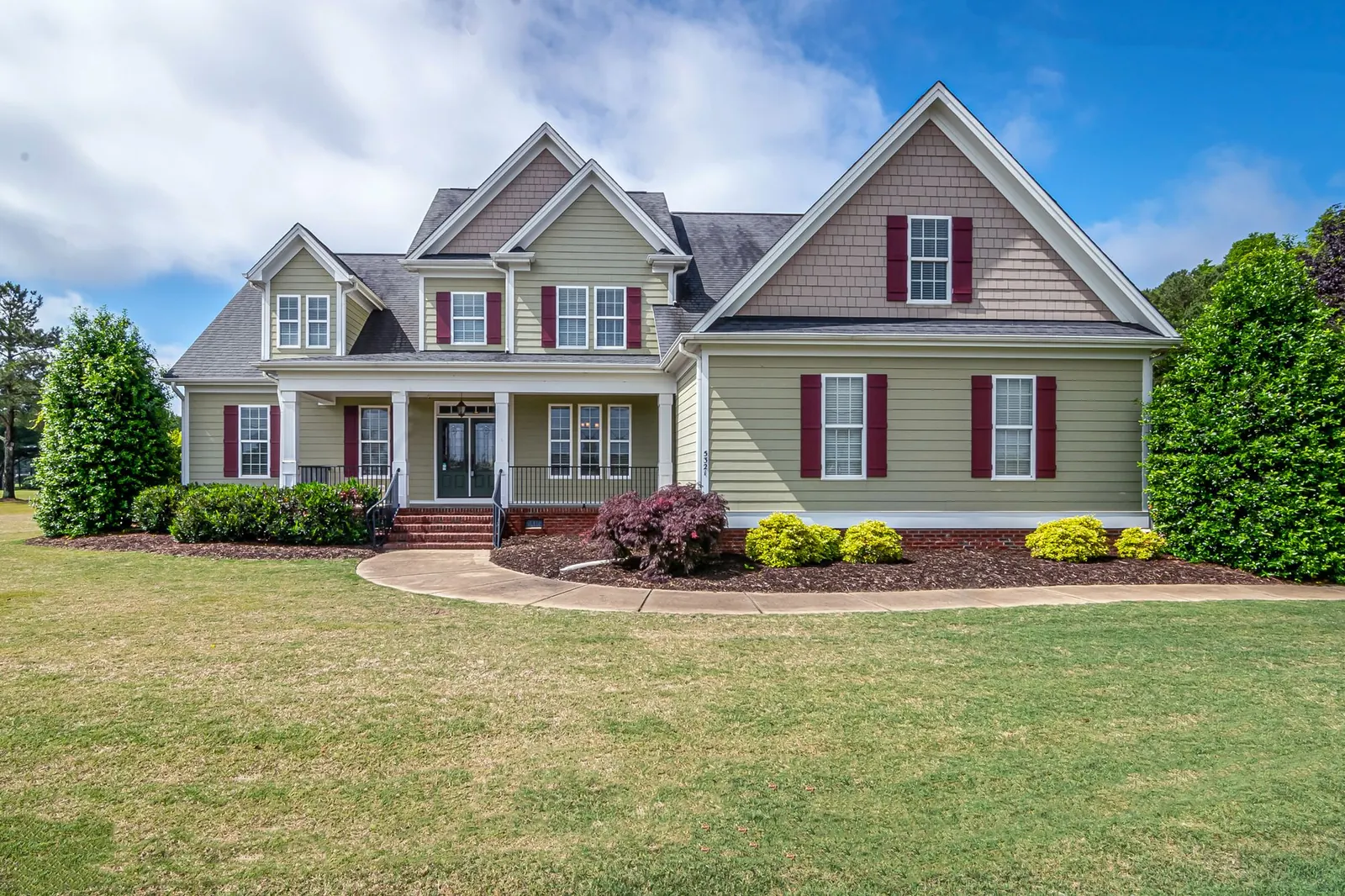 A two-story home with a covered front porch